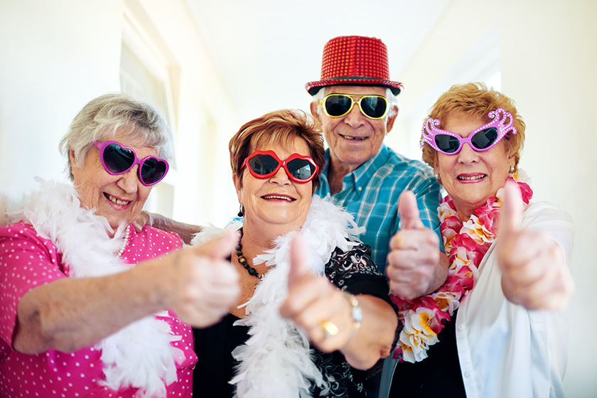 Heres to us the cool kids. a group carefree elderly people wearing sunglasses and showing thumbs up to the camera